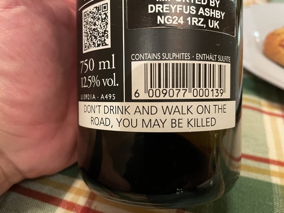 The back label of a wine bottle, featuring the warning: DON’T DRINK AND WALK ON THE ROAD, YOU MAY BE KILLED’