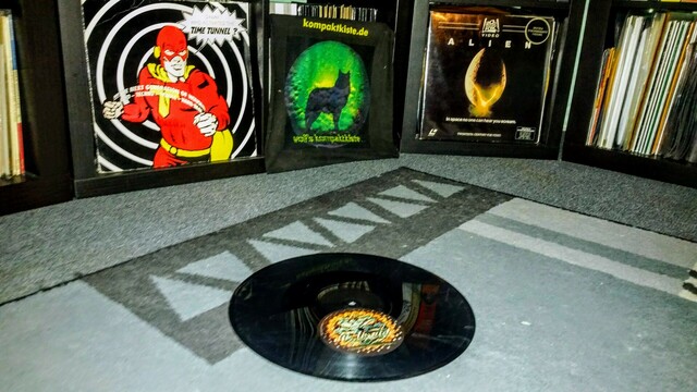 vinyl record with misplaced label lying on the carpet (for the cats). "Time Tunnel" cover, kompaktkiste totebag, and the "Alien" laserdisc cover in the background. 