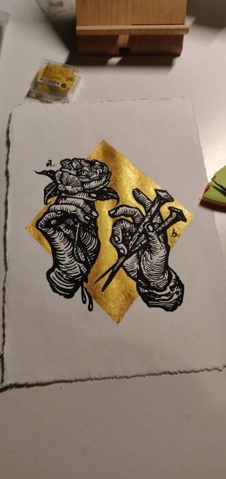 New drawing. Black wood it like hands. One holding nails, one a rose and 2 drops of blood are dripping down. The back is gold and the paper is white.