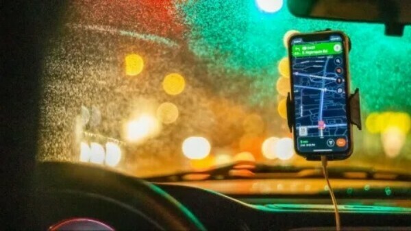 Photo of car windcsreen with phone mounted on window showing a map