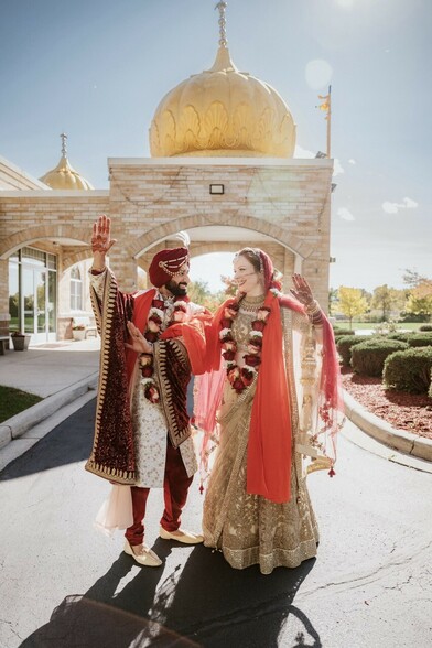 Sikh Bride and Groom dancing with the Sikh temple of Wisconsin in the background 