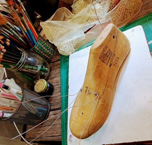 One shoe lasts with silver wires sticking out. Beginning of work.