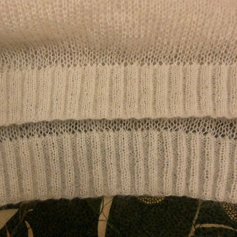 White mohair and silk knitted jumper showing the front and back sections. The rib has been attached with the wrong side so it’s a mixayke I have to fix some how.