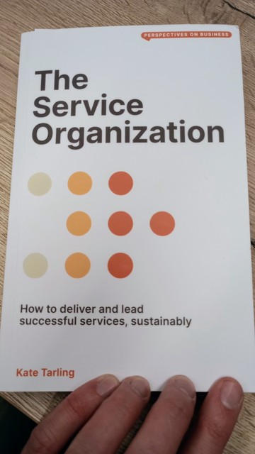 Photo of the front cover of The Service Organization. The cover has a grid of orange dots. 