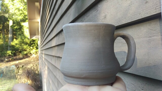 Clay cup against house 