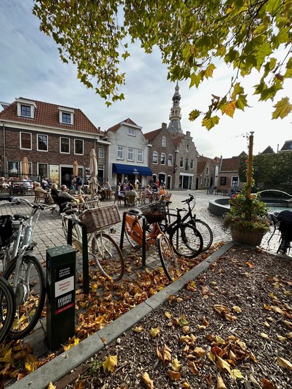 Zoomed out photo of an e-bike charging station, on a nice Dutch square.