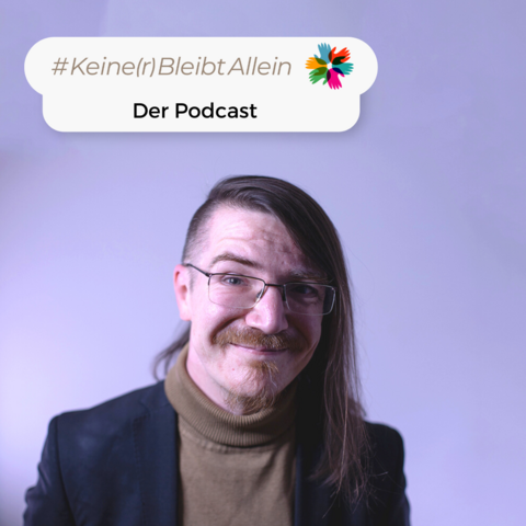 In einem Foto vor einer hellen Wand zu sehen ist Christian Fein. Über ihm steht als eingefügter Text "KeinerBleibtAllein - Der Podcast."