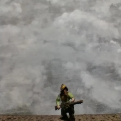 A blurred photo of a Last War miniature against a painted, foggy backdrop