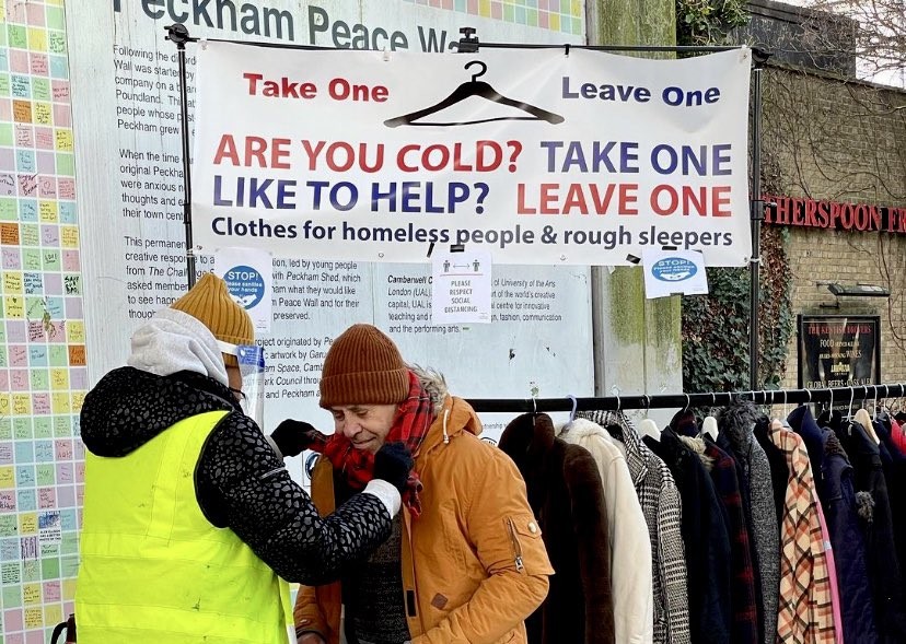 Kindness rail with warm clothes, and a banner saying:

"Are You Cold? Take One
Like To Help? Leave One"