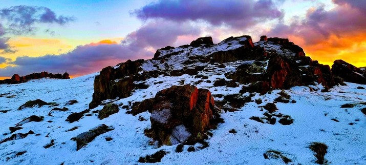 Sunset behind snowy rocky and crags at Beacon Hill Loughborough 