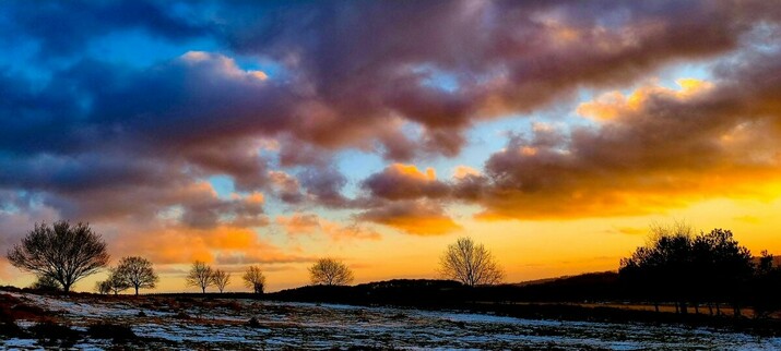 Sunset-filled clouds and silhouetted trees at Beacon Hill Loughborough 