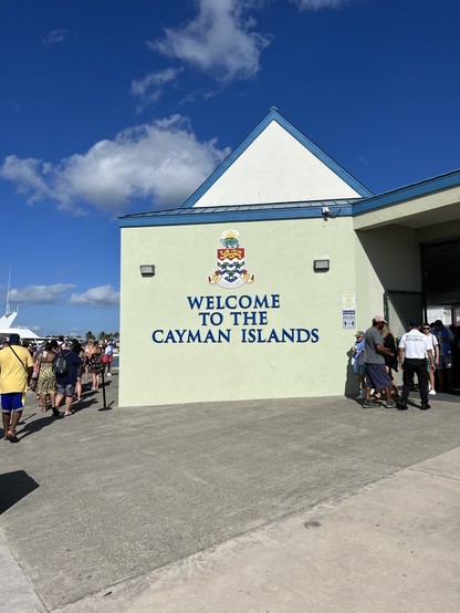 Wall at the cruise port in Grand Cayman with the crest of the islands and “Welcome to Cayman Islands” underneath.