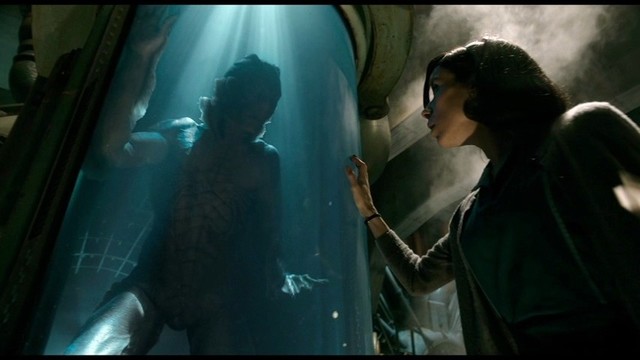 Sally Hawkins meeting the creature, who is submerged in a tank of water from The Shape Of Water.