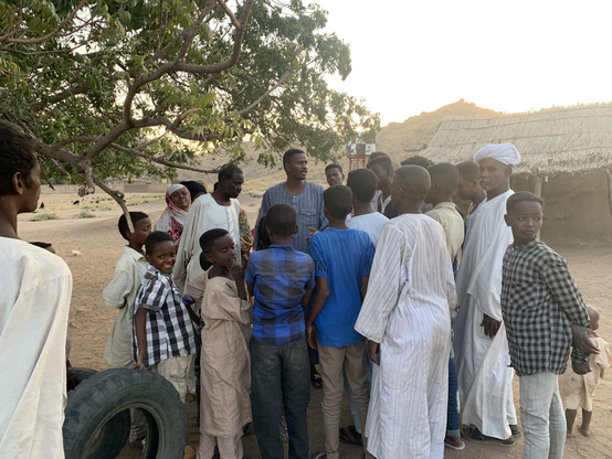 One of the Sudanese members of our team talking to the people at Jebel Moya. We always gather under the tree. 