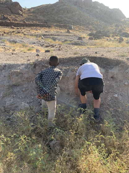 Abdul is my self-appointed helper but he likes to help the others too. Here they are looking at a potential area for a trench. 