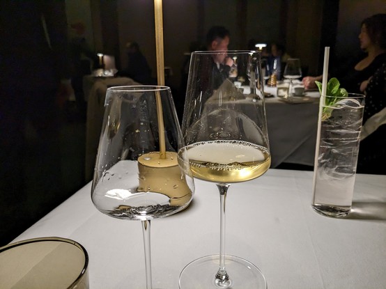 Two wine glasses pictures first is empty and the second is of the pour of wine in the glass. 