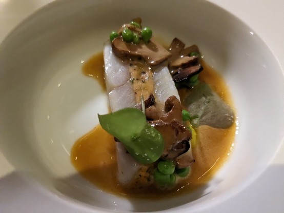 John Dory, lobster mousseline, snap peas, just de crustaces in a bowl