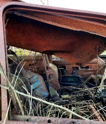 A look through the passenger front window. No passengers now. No padding on the seats either, just bare undulating springs and rusted blue metal backs. This made me think of both The Hitcher and Highwaymen. I hope the owner of this car never stopped to pick up the wrong Nordic blond.
