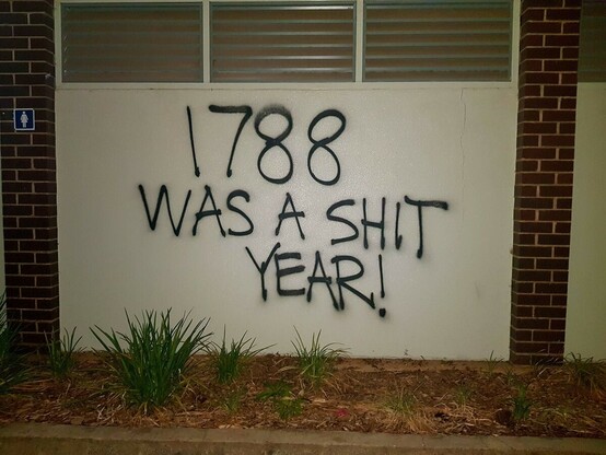 "1788 was a shit year" painted on a wall with black spray paint 