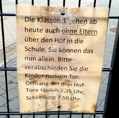 Verwitterter Hinweiszettel am Tor zum Schulhof einer Grundschule in Leipzig-Kleinzschocher: 

"Die Klassen 1 gehen ab jetzt auch [unterstrichener Text Anfang] ohne Eltern [unterstrichener Text Ende] über den Hof in die Schule. Sie können das nun allein. Bitte verabschieden sie die Kinder nun am Tor. Öffnungszeiten der drei Hoftore täglich 7.35 Uhr, Schließung 7.50 Uhr."