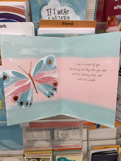 Inside of the card also features a picture of a blue, pink and white butterfly. Message inside reads “I am so proud of you for being exactly who you are and for sharing that self with the world”