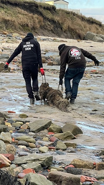 Sea Shepherd UK volunteers removing ghostnet from Newbiggin beach.