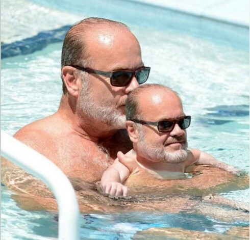 Kelsey Grammer in pool holding miniature version of self.