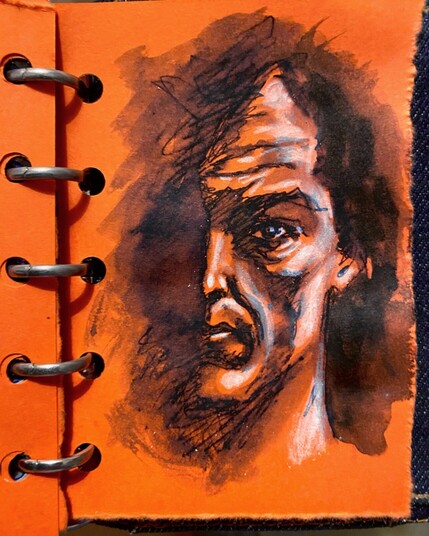 Ink, wash and Pencil sketch of a man’s face partially in shadow, drawn on orange paper