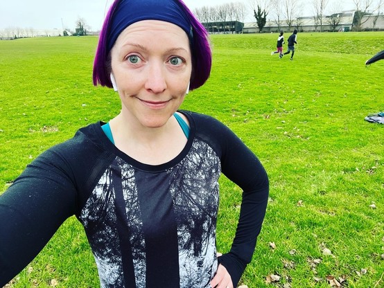 Pale white purple-haired lady in running gear pre-run