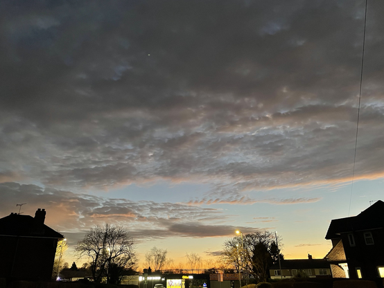 Sunrise over the local shops. The sky is deep lavender and gold. 