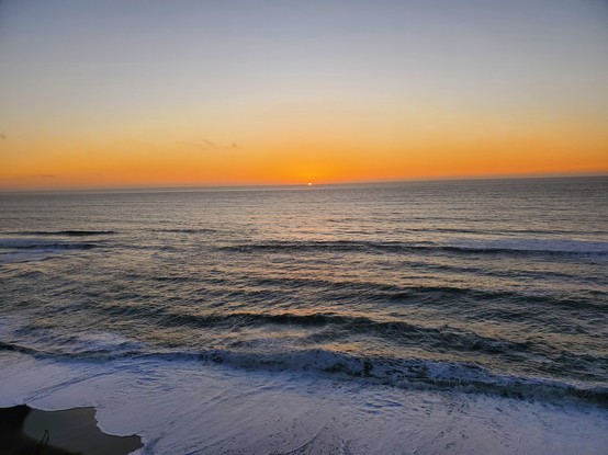 Lovely orange afterglow with gentle waves.