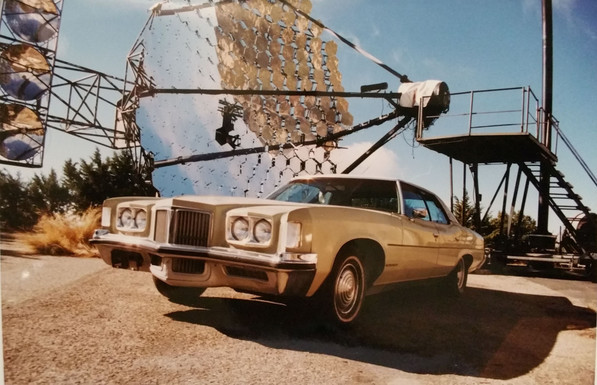 An astronomer's car posing in front of a telescope at Mount Hopkins, Arizona