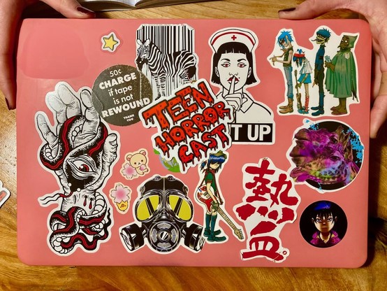 Laptop lid with a lot of overlapping stickers