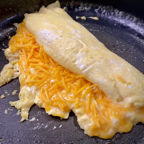 Rolling up cheese omelette 