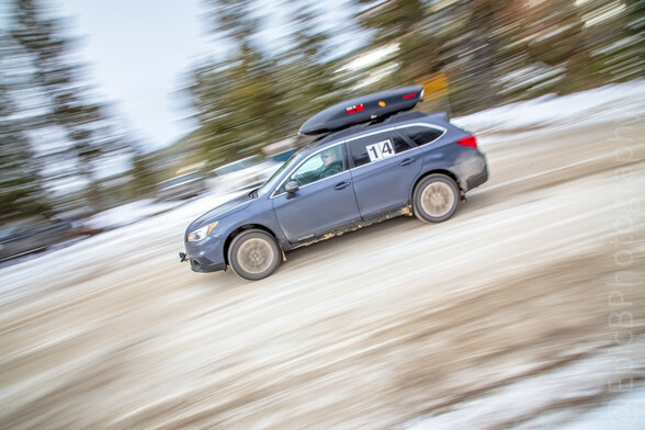 Same car driving in the day. The background is blurry to emphasize the speed of the car