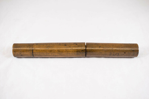 Photograph of the first stethoscope, made out of wood. It essentially is a long wooden cylinder. 