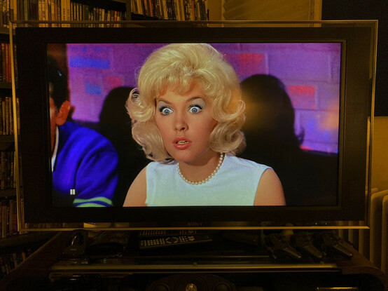 Stella Stevens in the movie The Nutty Professor. Stella has a look of utter astonishment as the character Buddy Love makes his first entrance.