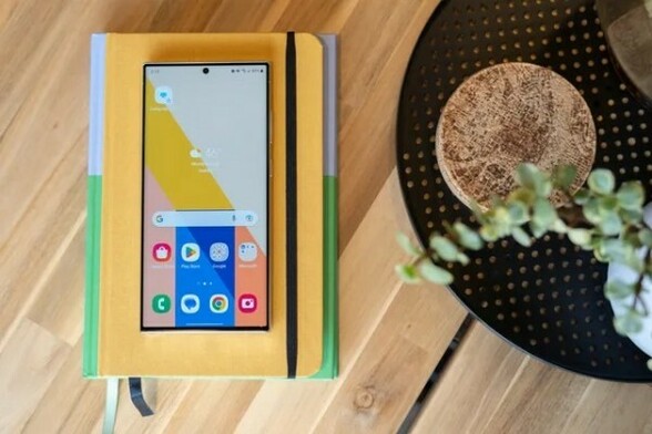 Samsung Galaxy S23 phone resting on top of a journal or diary.