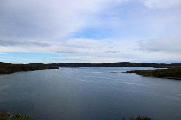 Big body of water under a cloud sky