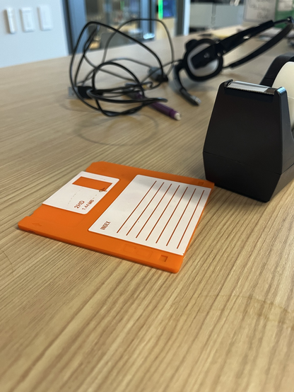 A 3.5 inch floppy disk sitting on a desk