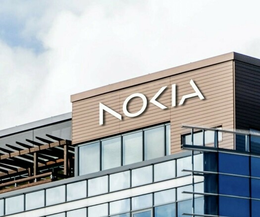 A picture of a building with the new NOKIA wordmark on the facade in large silver letters. The angular, capitalised stylised wordmark notably omits the second stem of the N and the stem of the K. This leads some to read those letters as A and C respectively.