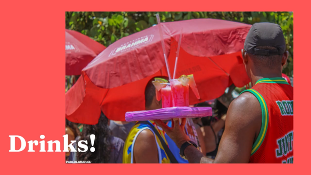 On pink background, photography of a street seller of red drinks with a red umbrella in the background.
Overlayed, white text: Drinks! 