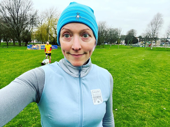 Pale white lady in cold weather running gear before Parkrun 