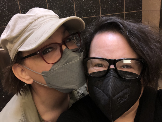 Tiffany, my wife, and I wearing eye protection and respirator masks, staying COVID-safer while traveling.