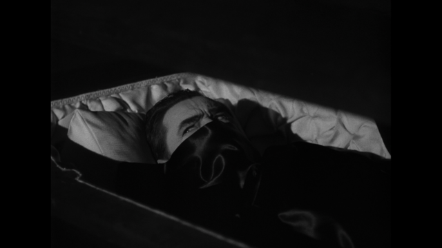 Bela Lugosi as Dracula lying in a coffin
