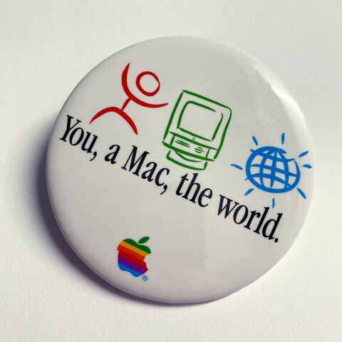 Apple promotional button with the text:

You, a Mac, the world.