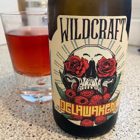Photo of wonderful cider bottle label. 
WildCraft - Delawaken 

Artwork of white skull, with red roses in the eye sockets, and red raspberries pouring out of the mouth. 