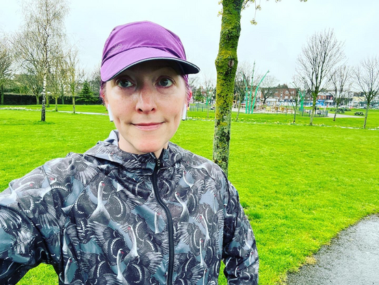 Pale white lady in running rain gear before Parkrun 