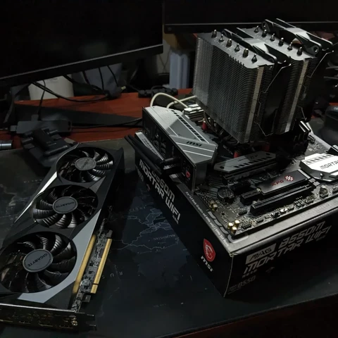 MSI motherboard with installed components next to a GPU
