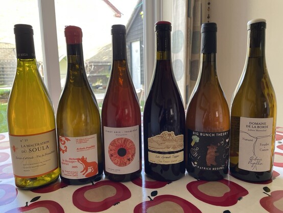 Six bottles of wine sitting on a table